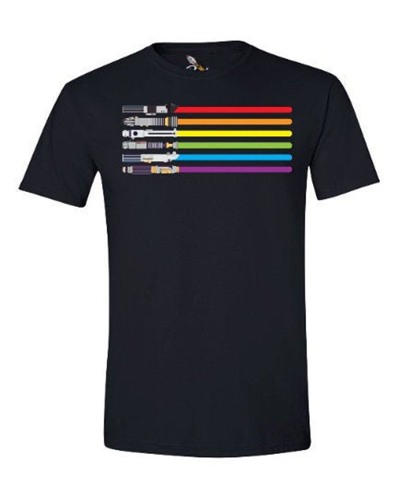 K&ouml;nnte beinhalten: Ein schwarzes T-Shirt mit einem Regenbogen-Design mit Lichtschwertern. Die Lichtschwerter sind in einem Regenbogenmuster angeordnet, mit Rot, Orange, Gelb, Gr&uuml;n, Blau, Indigo und Violett.