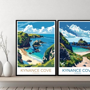 May include: Two framed prints of Kynance Cove in Cornwall, England. The prints feature a colourful illustration of the cove with a sandy beach, blue water, and green cliffs. The text "Kynance Cove, Cornwall" is printed below each image.