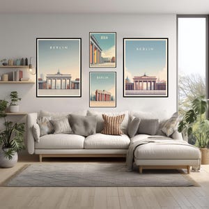 May include: Four framed art prints featuring Berlin landmarks. Each print has a black frame and depicts a different architectural view of Berlin, with the word "BERLIN" at the top. The prints are displayed above a white sofa.