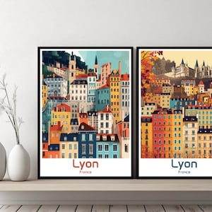 May include: Two framed illustrations of the city of Lyon, France. Both illustrations feature colourful buildings and the text "Lyon, France".