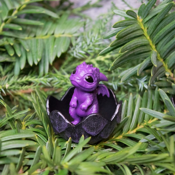 Newborn purple and black dragon in egg. Little miniature of dragon!