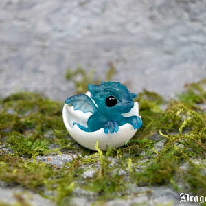 Newborn ocean-clear resin dragon in egg. Little miniature of dragon!