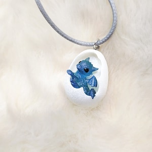 Pendant with blue-clear resin newborn dragon in the egg!