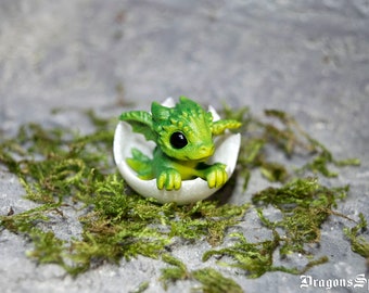 Newborn green dragon in egg. Little miniature of dragon!