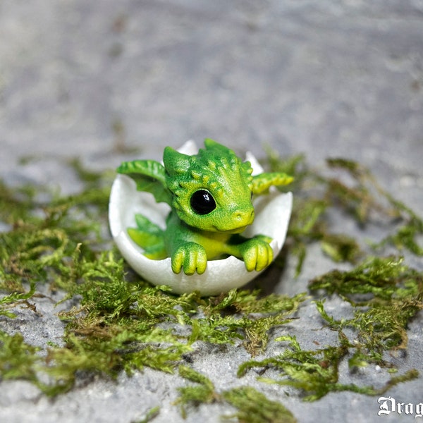 Newborn green dragon in egg. Little miniature of dragon!