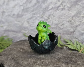 Newborn green dragon in egg. Little cute miniature of dragon!