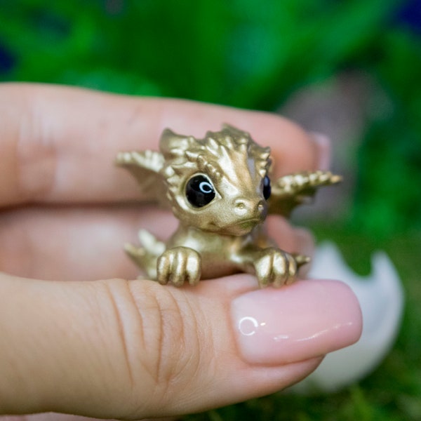 Newborn gold dragon in egg. Little cute miniature of dragon! Hatching Dragon!