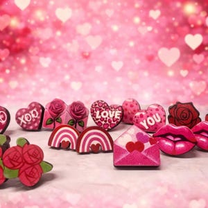 May include: A collection of Valentine's Day themed wooden decorations. The assortment includes heart shapes with "XOXO" and "LOVE" text, roses, lips, and an envelope with hearts. The color palette is primarily pink and red.