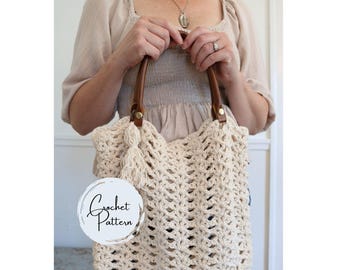 May include: A crocheted tote bag with a brown leather handle and a tassel. The bag is made with a white yarn and has a lacy pattern. The text "Crochet Pattern" is visible on a white circle.