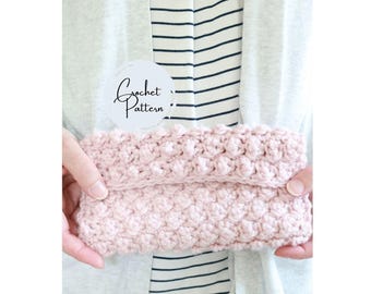 May include: A pink crocheted clutch purse with a white circle label that says "Crochet Pattern".