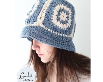 May include: A blue and cream crochet bucket hat. The hat features a square pattern design with a brim. The hat is handmade and has a Crochet Pattern logo in the bottom left corner.