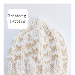 May include: A white knitted hat with a textured pattern. Knitting Pattern.