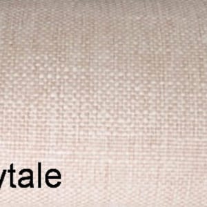 May include: A close-up of a beige fabric with a subtle woven texture. The text "Whisper Fairytale" is printed in black at the bottom of the image.