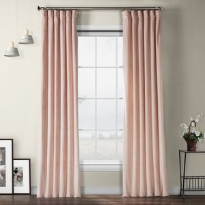 May include: A pair of blush pink velvet curtains hanging in a window. The curtains are lined and have a rod pocket top.