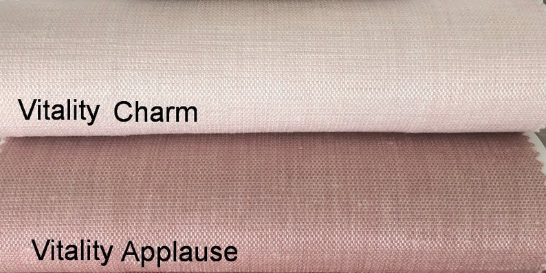 May include: Two fabric swatches, one a light pink and the other a darker pink. The top swatch is labeled "Vitality Charm" and the bottom swatch is labeled "Vitality Applause".