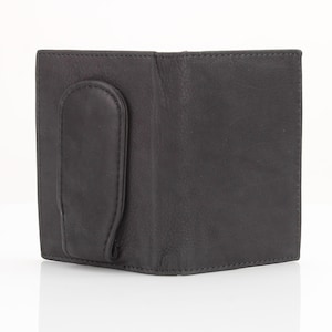 May include: A black leather wallet with a money clip. The wallet has a smooth, textured surface and a simple design.