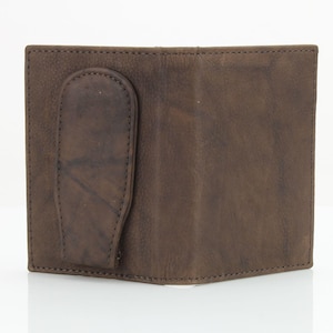 May include: A brown leather wallet with a money clip. The wallet has a flap that folds over to close the wallet.