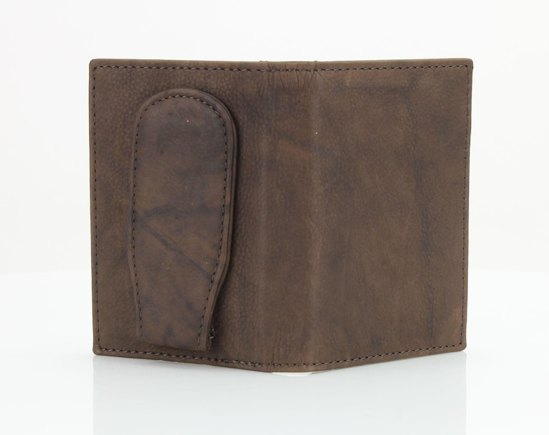 May include: A brown leather wallet with a money clip. The wallet has a flap that folds over to close the wallet.