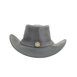 May include: A gray cowboy hat with a wide brim and a rounded crown. The hatband is adorned with a decorative element that appears to be a 12-gauge shotgun shell. The hat is made of a soft, pliable material.