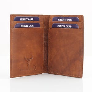 May include: A brown leather wallet with four card slots. The wallet is open and the slots are labeled "CREDIT CARD".