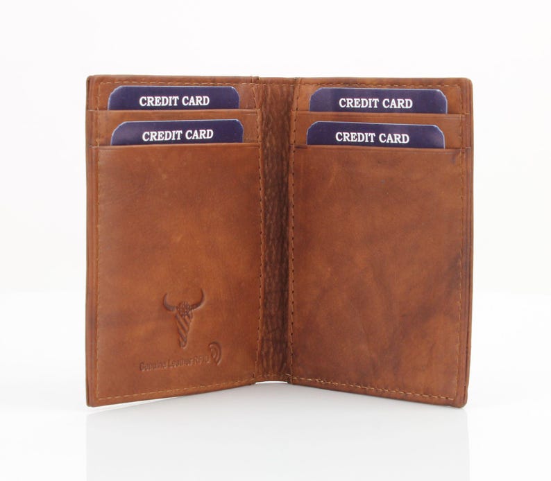 May include: A brown leather wallet with four card slots. The wallet is open and the slots are labeled "CREDIT CARD".