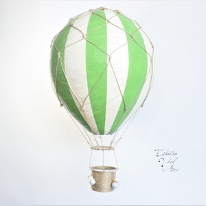 Hanging hot air balloon green and white of papier mache. Basket, net and bags handmade in Spain. Vintage model travel and fantasy.