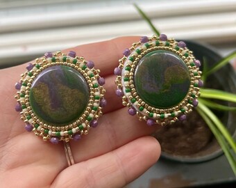 Green and purple beaded earrings backed with smoked moose hide