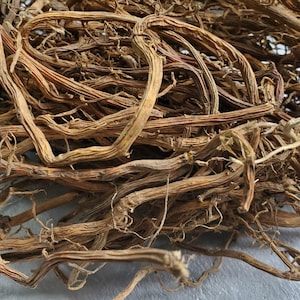 May include: A pile of dried, brown, twisted roots. The roots are tangled together and have a rough texture.