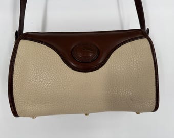 May include: A brown and cream leather shoulder bag with a gold buckle and a gold logo.