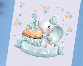 May include: A light blue and white birthday card with a cute cartoon elephant wearing a party hat and holding a cupcake with a lit candle on top. The cupcake has blue flowers and the text "Happy 1st Birthday" is written on a blue ribbon.