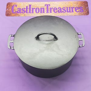 May include: A cast iron Dutch oven with a lid and handle. The pot is dark gray and has two side handles. The lid has a small handle. The text "CastIron Treasures" is above the pot.