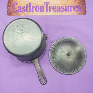 May include: A black cast iron pot with a lid. The pot has a handle and the text "Wagner Ware Sidney, O." on the side. The lid has a knob in the center.