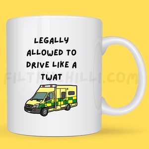 Puede incluir: Taza de cerámica blanca con una ilustración en blanco y negro de una ambulancia y el texto "Legally Allowed to Drive Like a Twat".