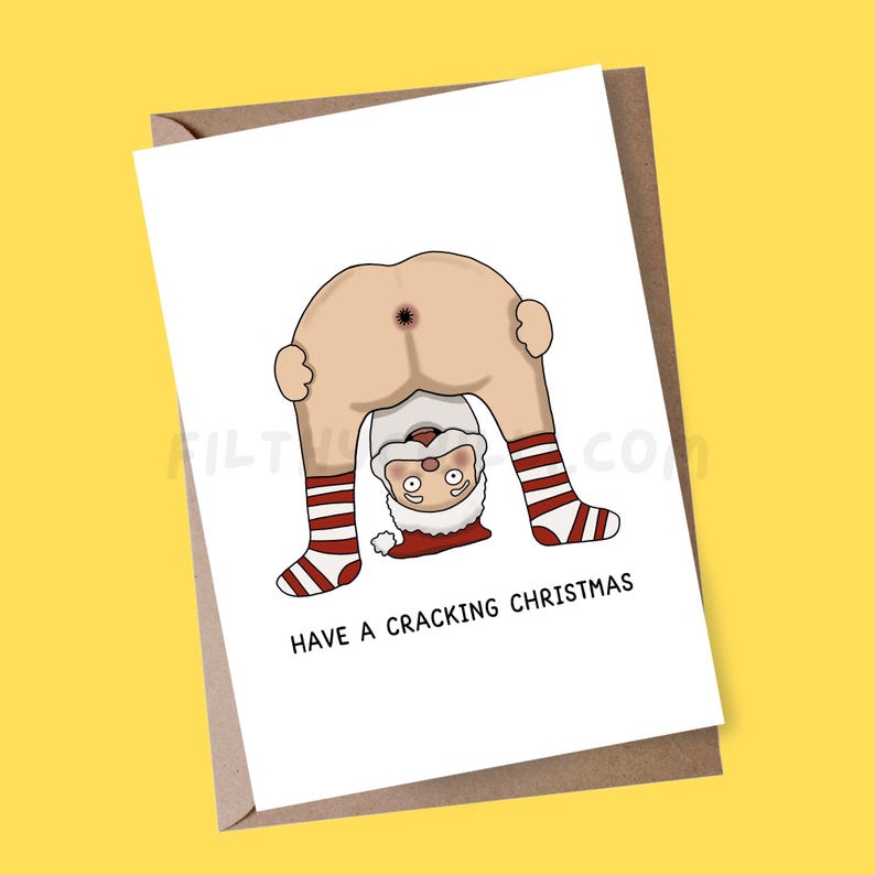 May include: A white Christmas card featuring a cartoon Santa Claus bent over, showing his backside. Santa is wearing red and white striped socks. The card reads "HAVE A CRACKING CHRISTMAS" in black text.
