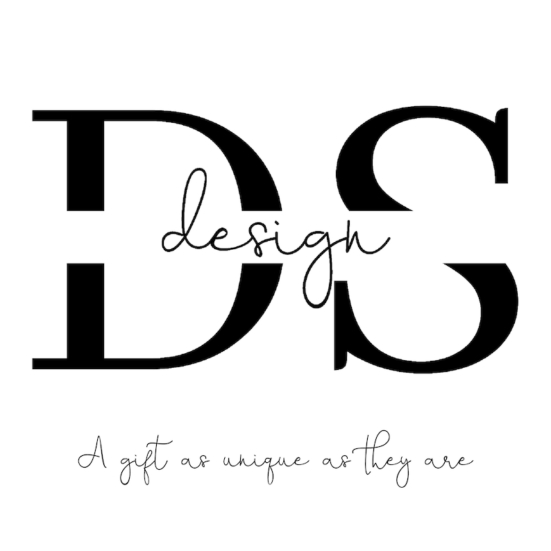 May include: Black and white logo design with the letters "DS" and the word "design" written in cursive between the letters. The text below the logo reads "A gift as unique as they are".
