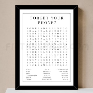 May include: A black and white word search puzzle with the words "Forget Your Phone?" at the top. The puzzle includes words related to bathroom and beauty products, such as "towel", "soap", "toothbrush", "body wash", "makeup", and "conditioner".