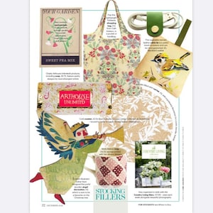 May include: A selection of stocking fillers for the festive season, featuring a cork coaster, a mug with a floral design, a wooden angel decoration, and a small leather cable tie with a bird illustration. The text "Stocking Fillers" is printed in large letters at the bottom of the image.