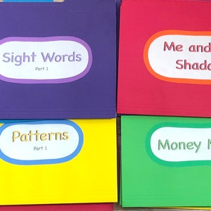 May include: Four colorful file folders with labels. The top left folder is purple with the label "Sight Words Part 1". The top right folder is red with the label "Me and My Shadow". The bottom left folder is yellow with the label "Patterns Part 1". The bottom right folder is green with the label "Money Match".