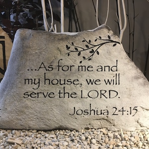 May include: A gray stone with the inscription "...As for me and my house, we will serve the LORD. Joshua 24:15" in black lettering.