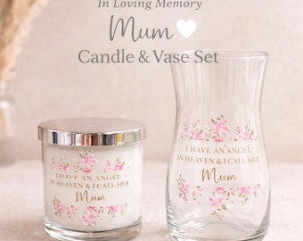 May include: A candle and vase set with floral accents and the text "I HAVE AN ANGEL IN HEAVEN & I CALL HER Mum". The candle has a silver lid. The vase is clear glass. The set is designed as a memorial.