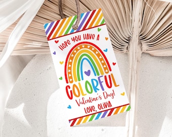 May include: A colorful rainbow with hearts and the text "Hope you have a colorful Valentine's Day! Love, Olivia" on a white background with a striped border.