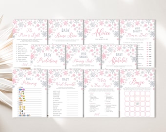 May include: A set of ten printable baby shower game cards featuring a pink and silver snowflake design. The games include "The Price is Right", "Baby Name Race", "Baby Predictions", "Who Knows Mommy Best?", "Baby Alphabet", "Emoji Pictionary", "Baby Word Scramble", "What's in Your Purse?", and "Bingo".