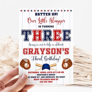 May include: Baseball-themed birthday party invitation in red, white and blue. The invitation reads "Batter Up! Our Little Slugger is turning Three. Swing on over to help us celebrate Grayson's Third Birthday!" The invitation includes the date, time and location of the party. RSVP information is also included.