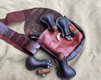 Muzzleloading leather round ball small flask.