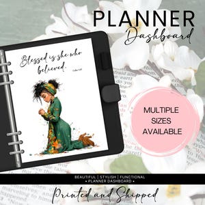 May include: Black planner dashboard with the text "Blessed is she who believed." and an illustration of a woman in a green dress. The planner has a black cover and the text "MULTIPLE SIZES AVAILABLE". The words "Printed and Shipped" are also visible.
