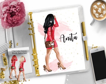May include: A white planner with a gold ring binder. The planner has a pink and white watercolor background with gold stars. A woman in a red dress and black hair is holding a coffee cup. The text "Anita" is written in black cursive on the planner.