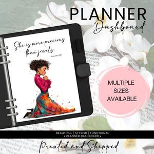 May include: Black planner dashboard with a watercolor illustration of a woman kneeling in prayer. The planner has the text "She is more precious than jewels" and "Multiple Sizes Available". The words "Planner Dashboard" are also visible.