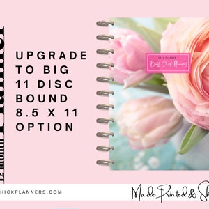 May include: A pink 12-month planner with a floral cover featuring pink flowers. The planner is disc-bound and offers an 8.5 x 11 inch option. Text on the planner includes "Upgrade to Big" and "Boss Chick Planners."