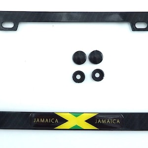 May include: Black license plate frame with a textured pattern and the Jamaican flag emblem. Includes four black mounting hardware pieces. The word "JAMAICA" is printed on the emblem.