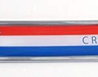 May include: A chrome-plated emblem featuring the Croatian flag design. The emblem has a rectangular shape with rounded edges and the word "CROATIA" in blue. The flag design includes red, white, and blue stripes, and the Croatian coat of arms.